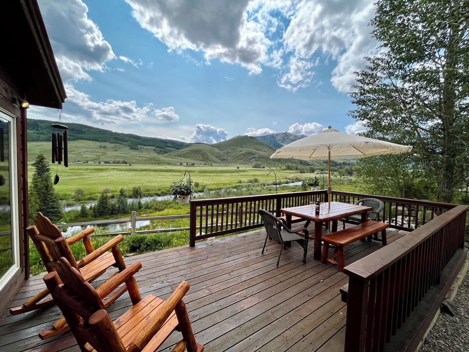 deck with expansive views of mountains and river