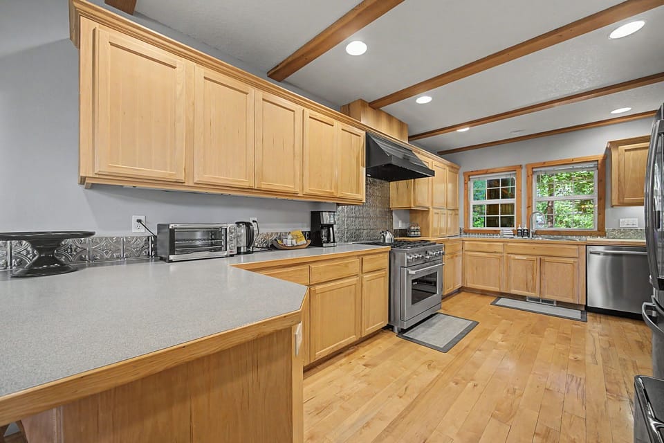 Enjoy casual dining or morning coffee at the kitchen counter, featuring comfortable seating.