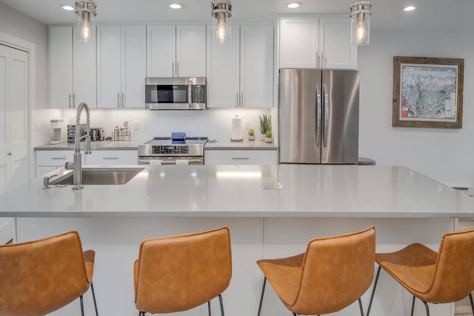 A large kitchen island doubles as extra space for meal prep, or the perfect spot to grab a quick snack with four bar stools to use.