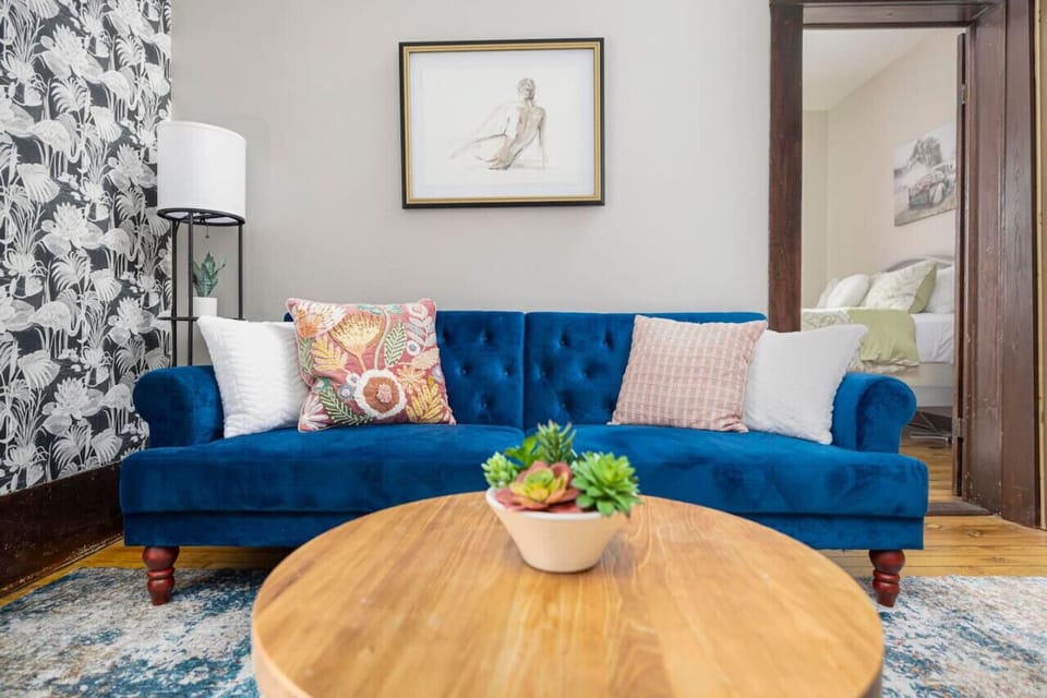 A blend of historic charm and modern style—this space shines with eye-catching wallpaper and cozy furnishings.