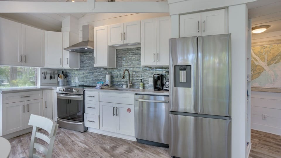 This beautifully updated kitchen blends modern convenience with coastal charm.