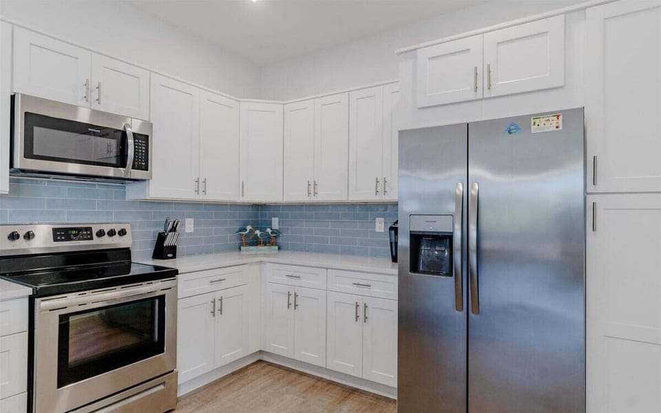 Fully equipped kitchen with stainless appliances, Keurig coffee maker, and generous prep space.