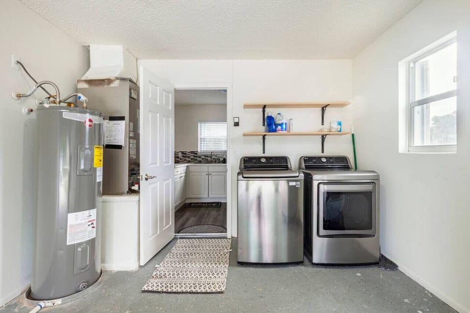 Spacious backyard with a huge tree, perfect for relaxing or family activities.