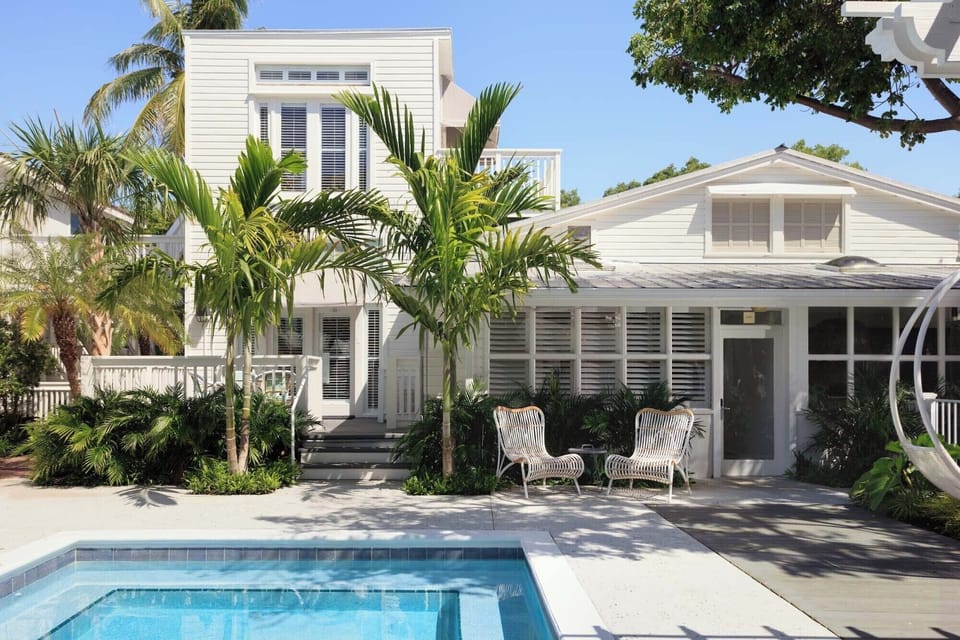 Arrive to a sunlit tropical villa with sparkling pool views.