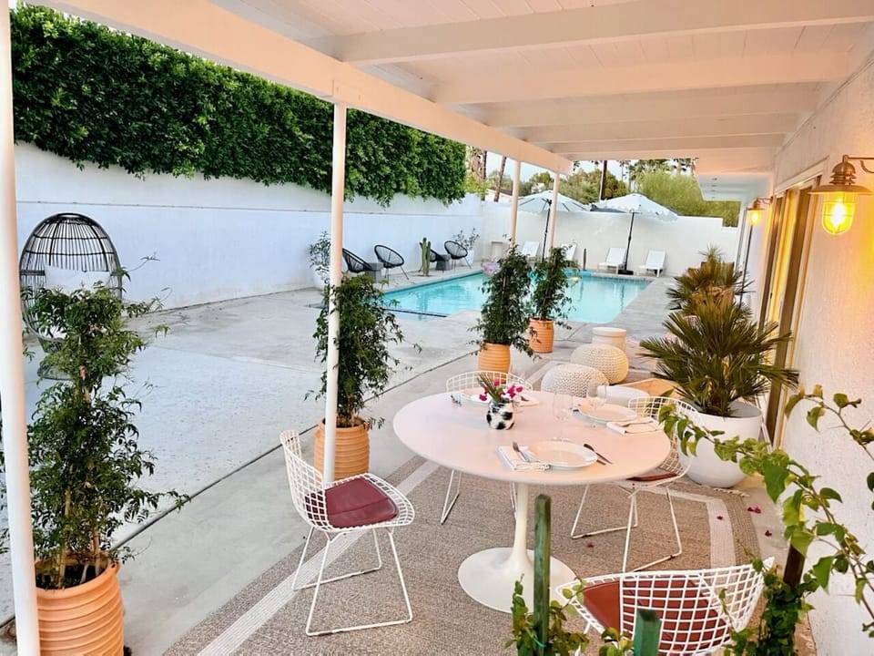 Our covered patio has a dining table as well as two lounge chairs and ottomans. 