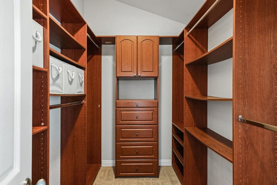 Walk in closet in primary bedroom.