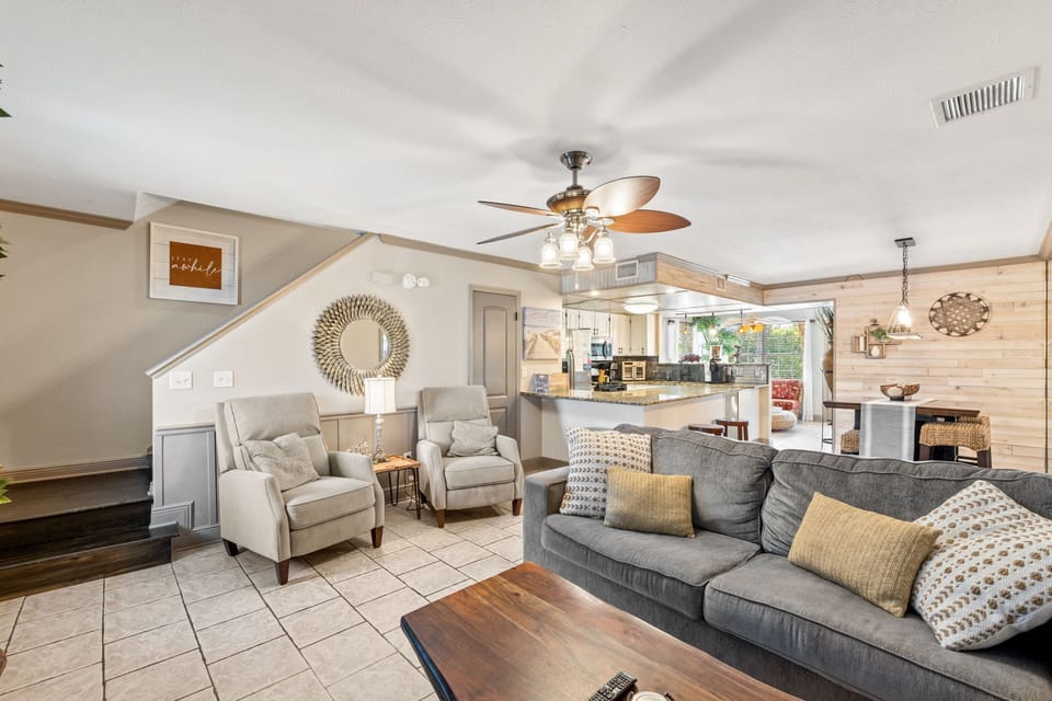 Living room with smart TV, sleeper sofa, half bathroom, and 2 accent chairs