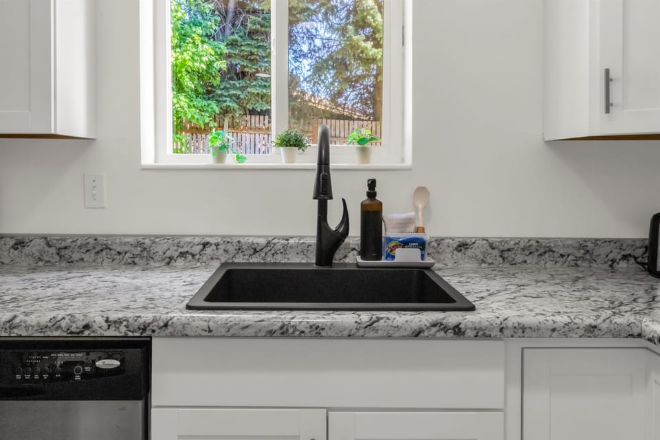 Big kitchen sink with great window looking out into the backyard.