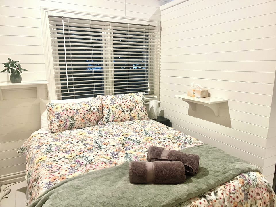 Queen bed with entry to Bathroom