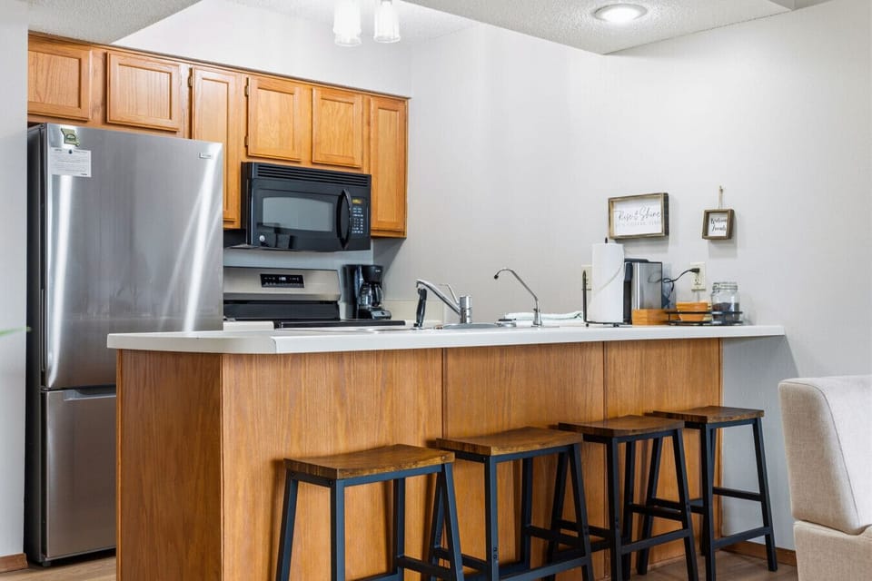 Enjoy a fully stocked kitchen and convenient bar seating, ideal for casual meals, snacks, or planning the day’s adventures.