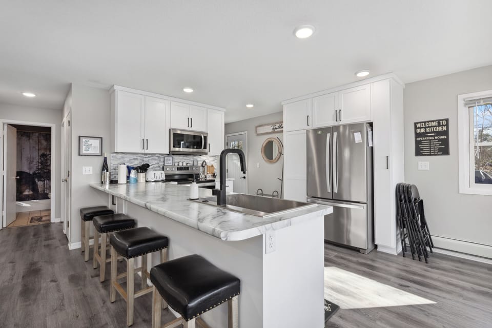 The breakfast bar includes four stools.