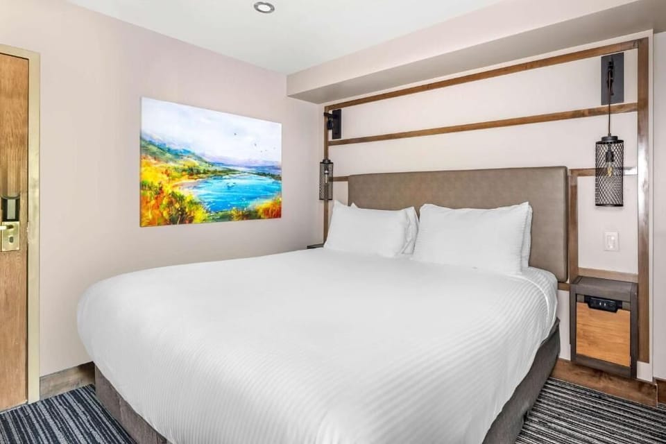 Relax in a serene bedroom with soft lighting and modern style.