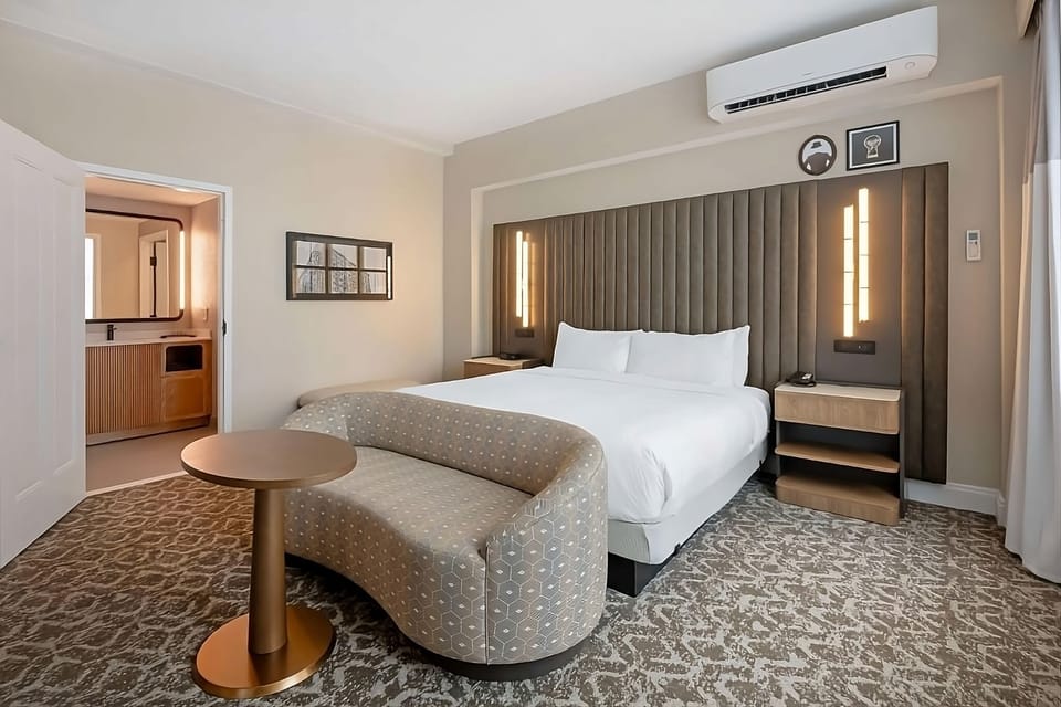 Unwind on plush bedding with a cozy lounge nook.