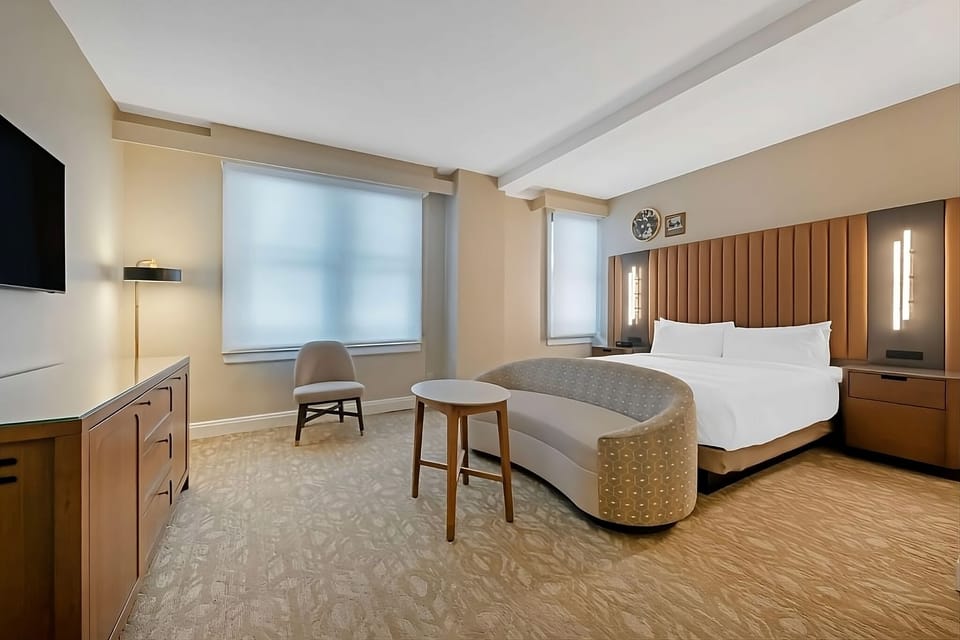 Recharge in a calm, airy room with modern furnishings.