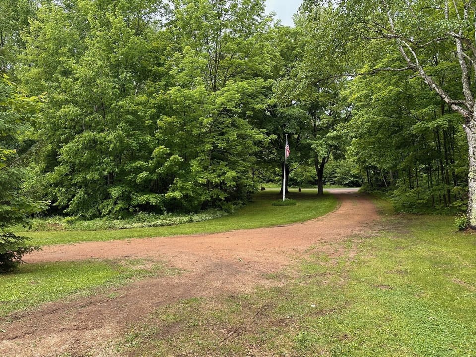 Private drive to large yard.  Parking is next to front door and in side yard.