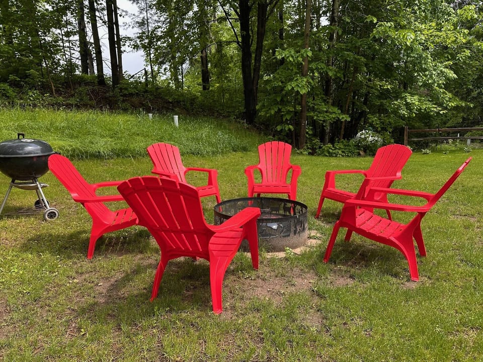 Huge yard with firepit and free wood.  More chairs stored on side of house too.