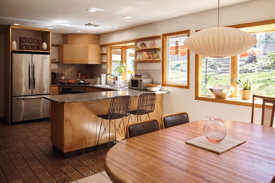 The open kitchen with peninsula flows directly from the dining area.