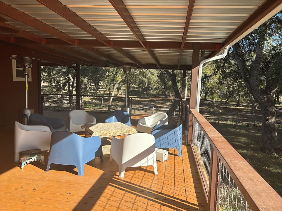 Outside deck with picnic table and outdoor ceiling fans
