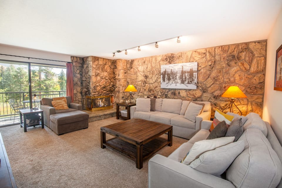 Open floor plan living room with mountain and lake views