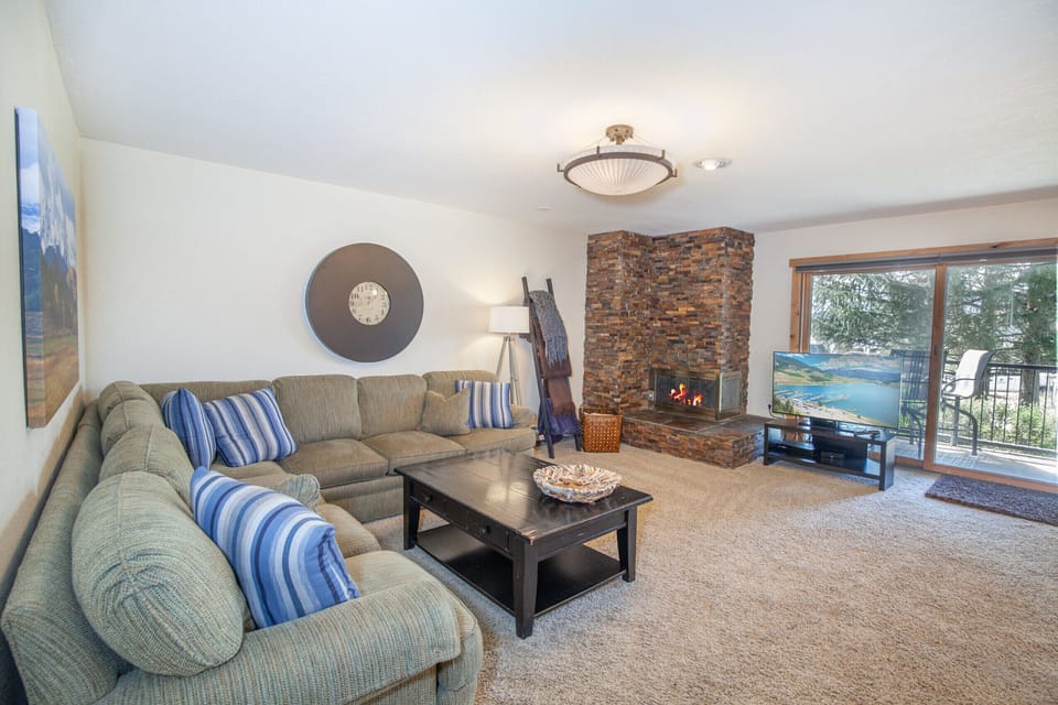 Open floor plan living room with mountain and lake views