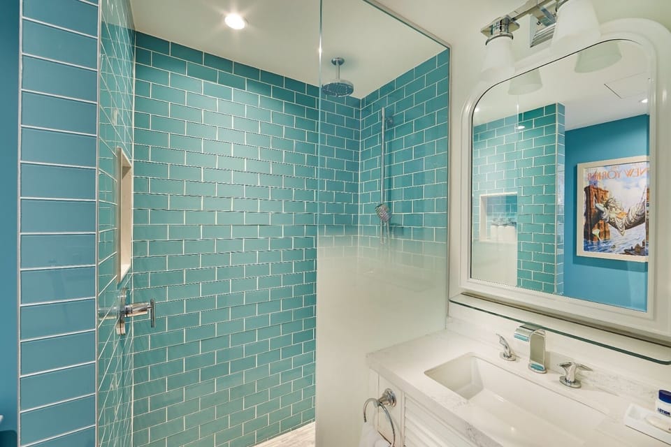 Refresh under a rain-style shower in sparkling turquoise tile.