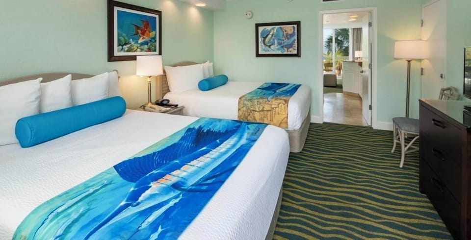 Stretch out on plush beds in a calm coastal room.