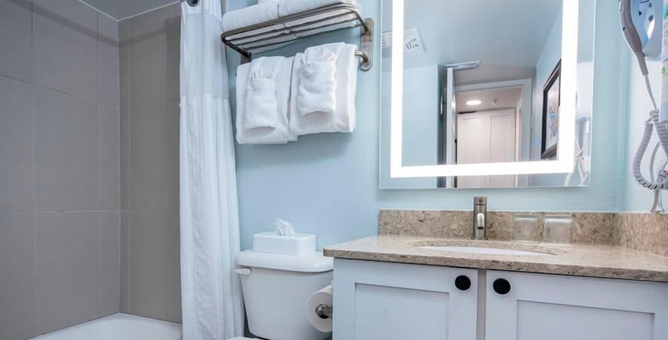 Enjoy a tidy bath setup with plenty of fluffy towels.