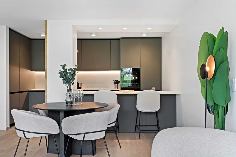 Indulge in culinary delights in our fully equipped kitchen that opens to a cozy dining nook.