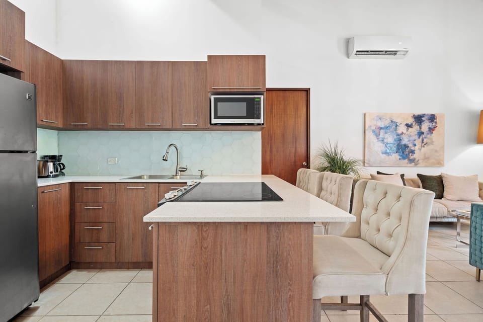 The kitchen is fully equipped with refrigerator, freezer, microwave, oven and toaster.