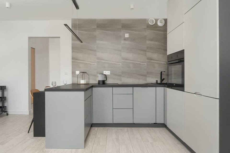 A sleek open-plan kitchen with modern appliances and a spacious island. Ideal for preparing meals and entertaining guests.
