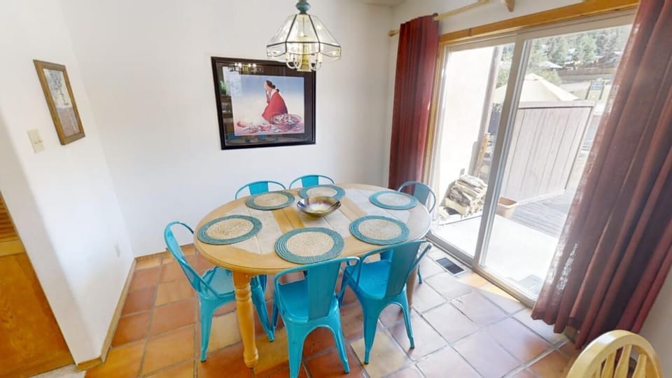 Gather around this sunny dining table for memorable meals together. The cheerful turquoise chairs and coastal artwork set a relaxed, welcoming tone for your vacation mornings and evenings.