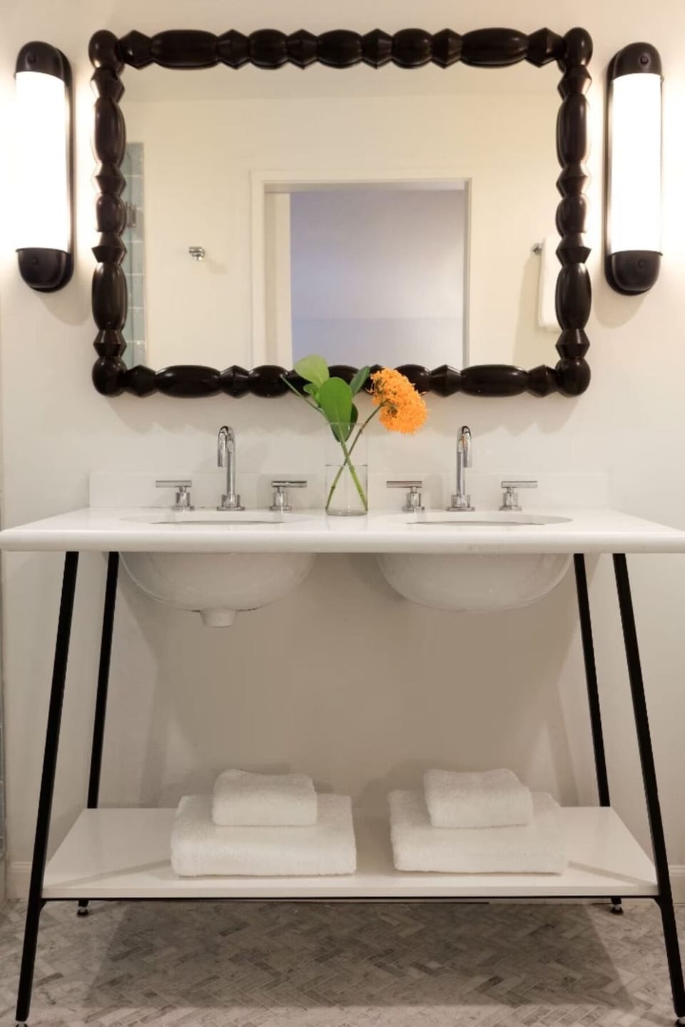 Refresh at the chic double vanity with spa-bright lighting.