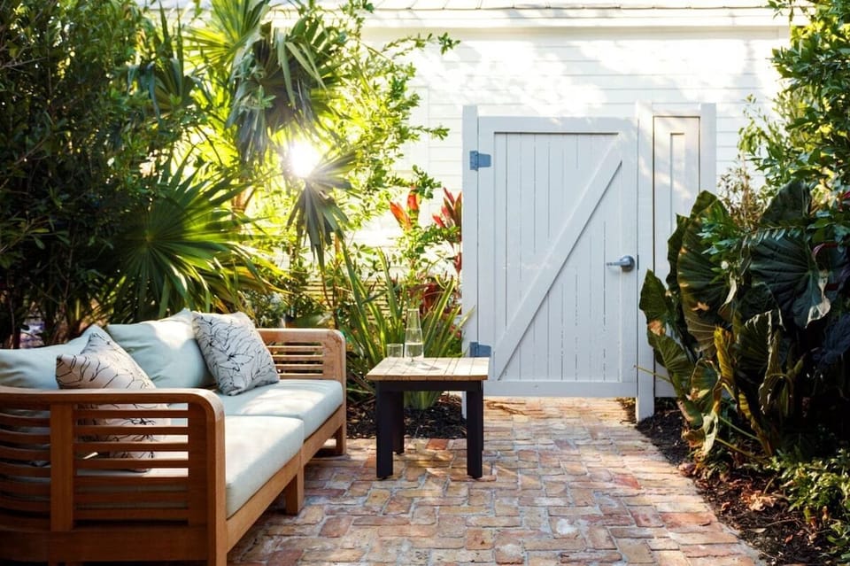 Unwind on the private patio surrounded by lush tropical greenery.
