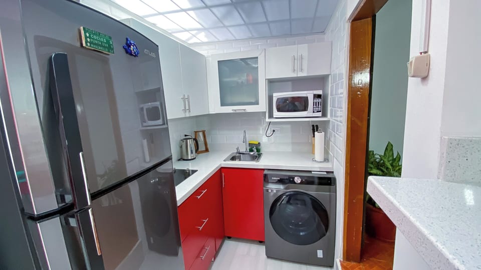 Full kitchen equipment with microwave, blender and air fryer.