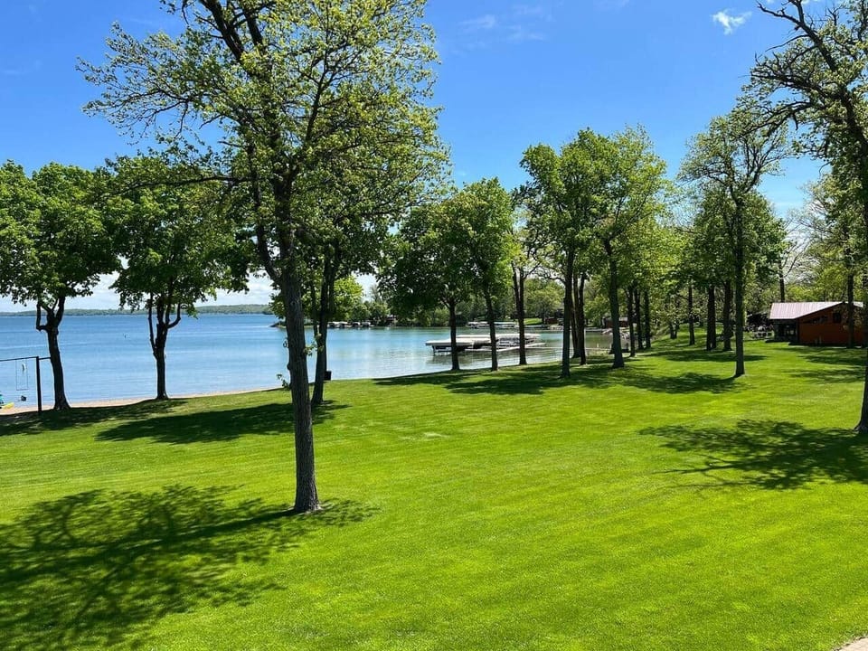 Lush, green grass leads down to the lake