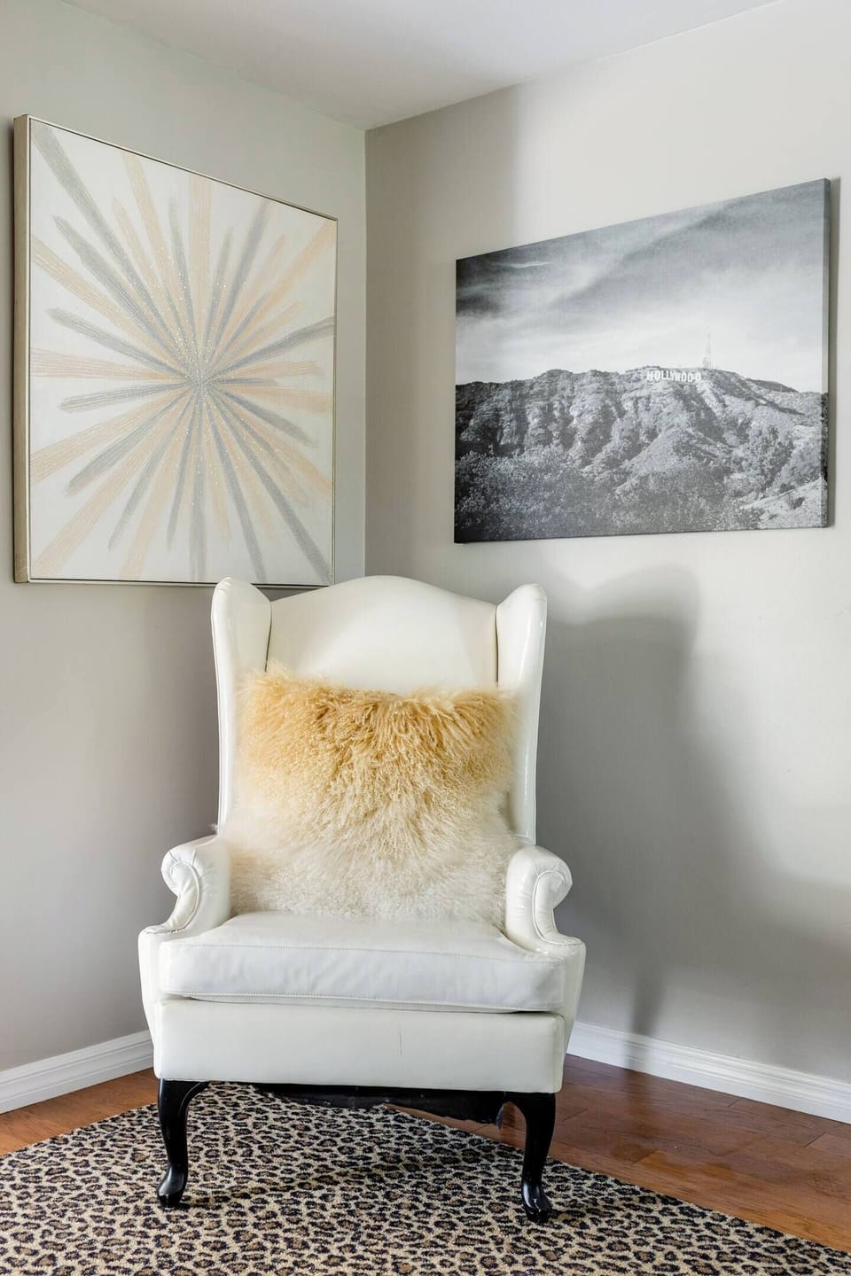 The living room of the home is adjacent to the dining area and offers seating at a small settee in front of the woodburning fireplace. There are also two wingback chairs to offer additional seating.