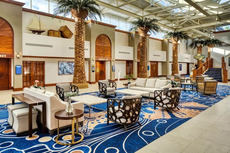 Unwind on plush seating beneath soaring, sunlit atrium ceilings.