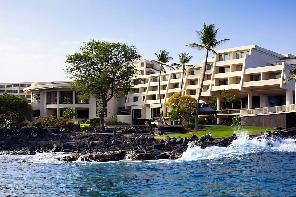 Stroll seaside pathways beside modern buildings and crashing waves.