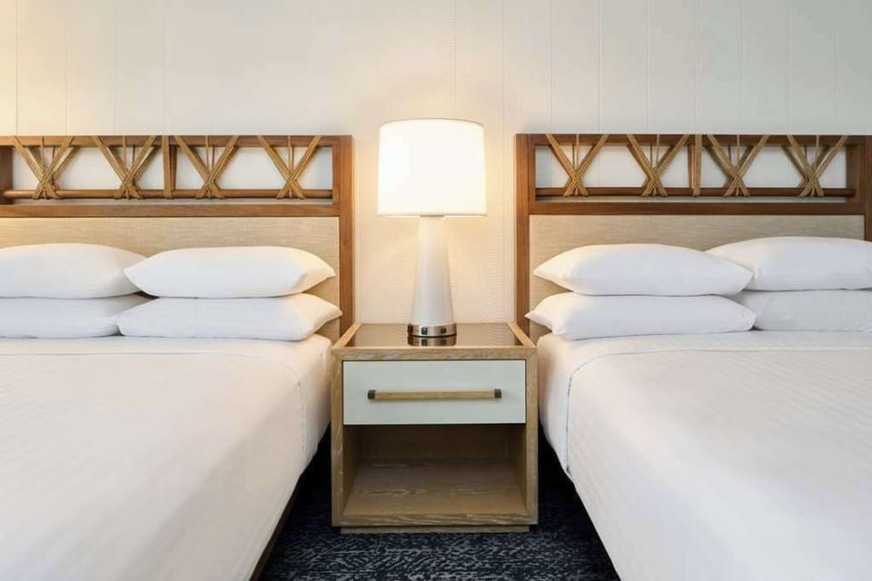 Drift into crisp linens with bedside lighting for late-night reads.