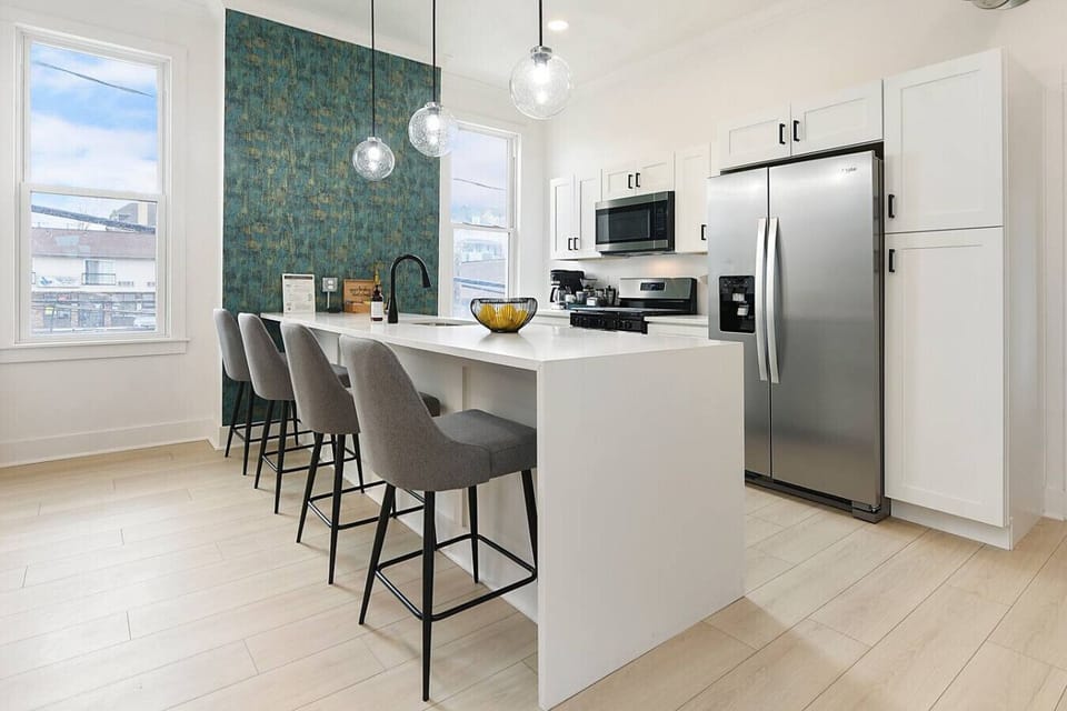 Bright, fully stocked kitchen with island seating and city views
