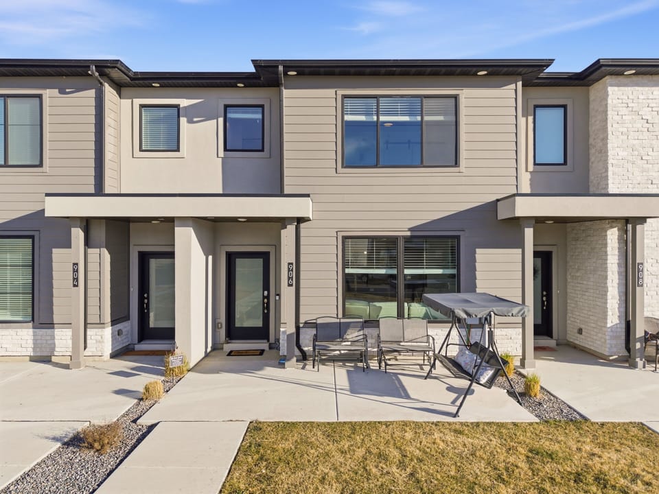 Front patio with two glider swings and a porch swing with canopy