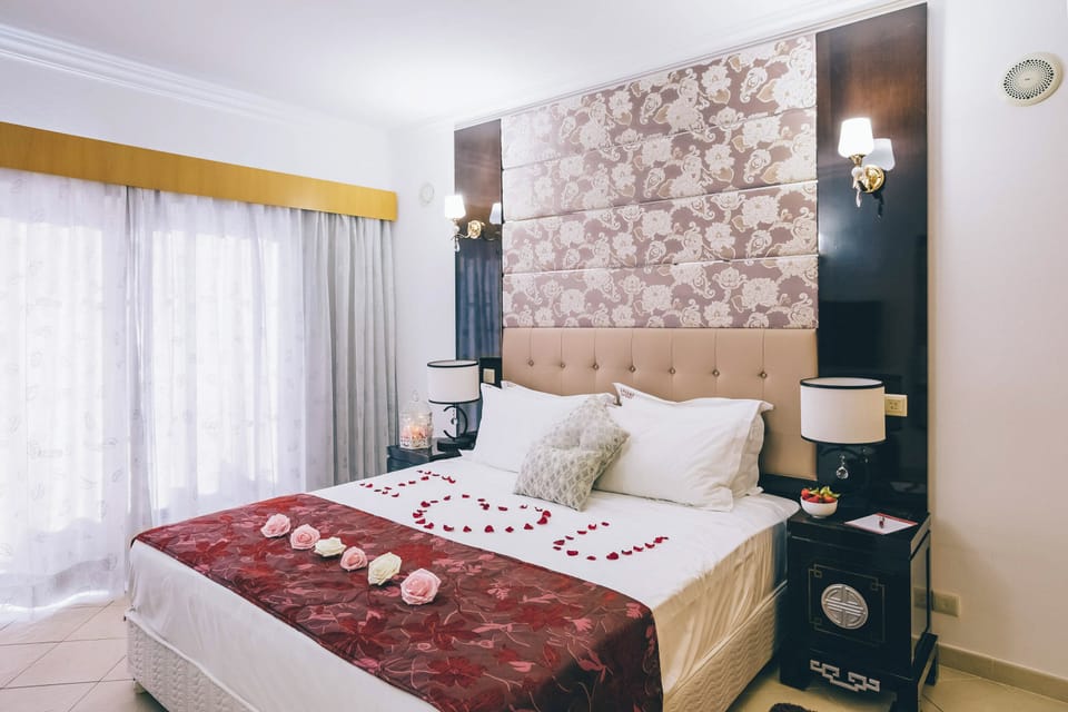 Drift off in a romantic setting with cozy bedside lighting.