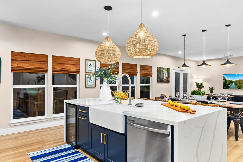 At the heart of the Black House is a beautifully designed chef’s kitchen featuring a dramatic 6-foot waterfall island, built-in wine fridge, custom cabinetry, and a charming farmhouse sink.