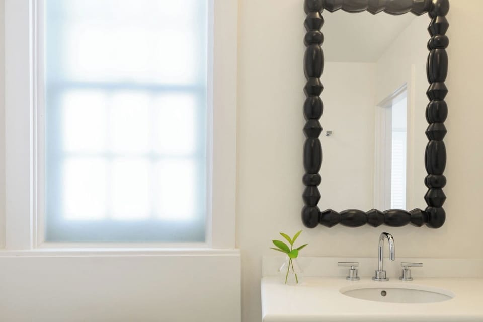 Refresh at the sleek vanity with spa-simple calm.