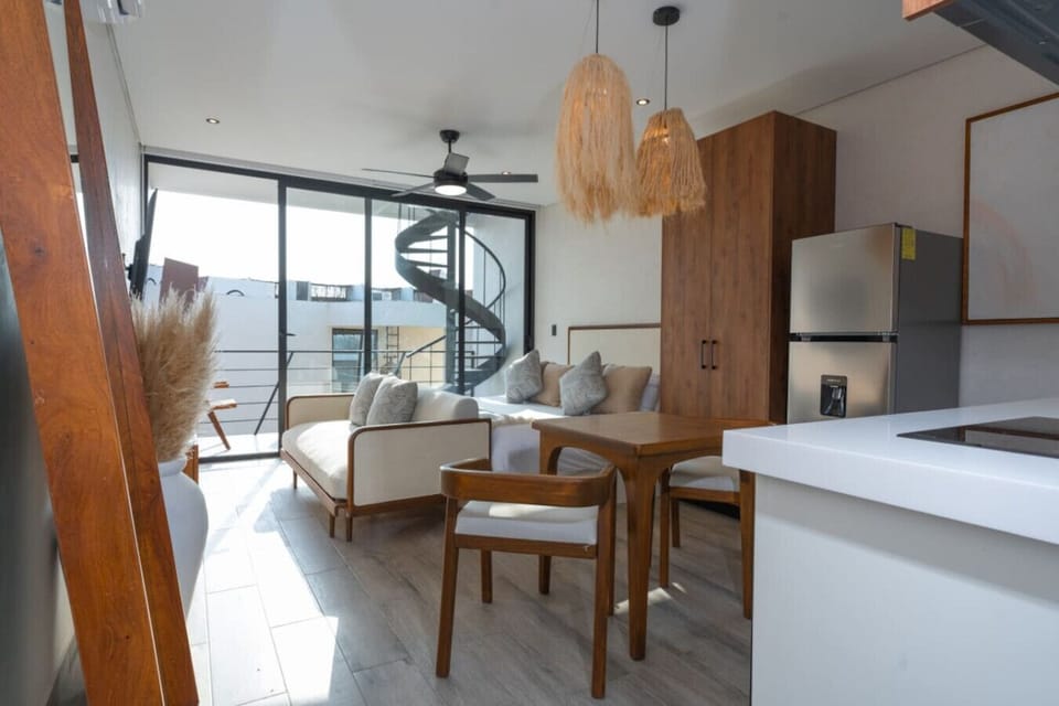 Studio with balcony, cozy living and modern decor.