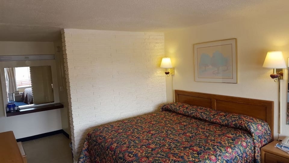 Unwind on the king bed beside a cozy sofa.
