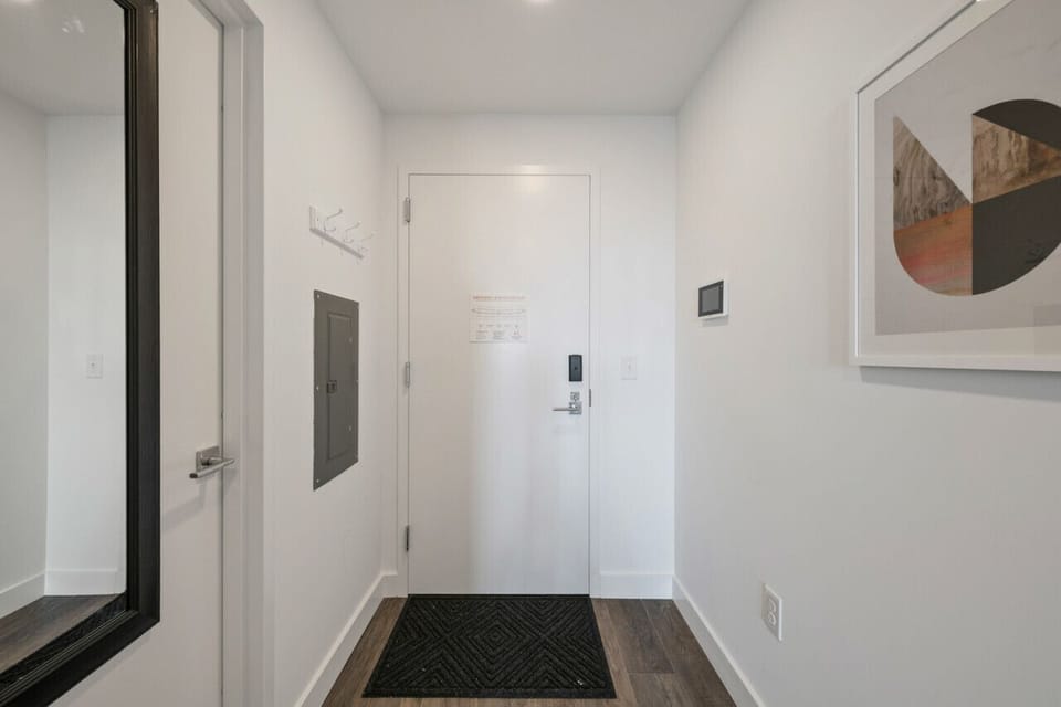 View of front door with bathroom on left