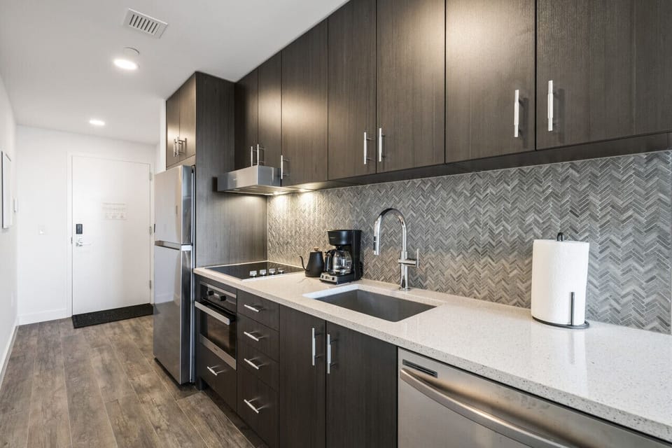 Modern kitchen with fridge, freezer, dishwasher, over and stop top