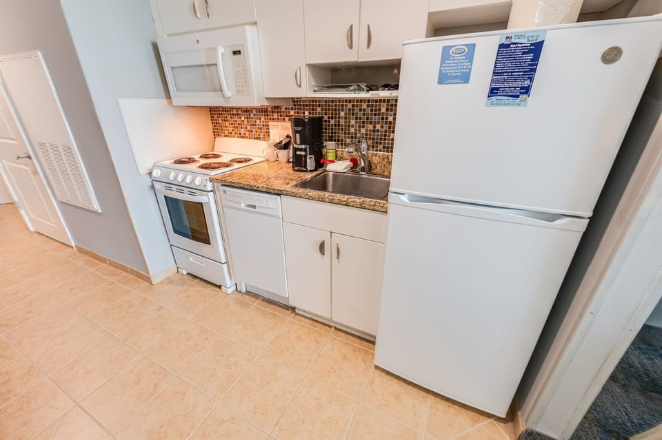 - Full kitchen with stove oven refrigerator and microwave for cooking   - Granite counters and tile backsplash add style to your beach meals   - Perfect vacation condo with everything needed for home cooked dining