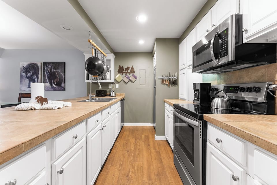 Full size kitchen featuring stainless steel appliances.